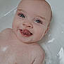 Adèle participe au concours pour gagner de l'argent avec cette photo : baby, bath, bathroom, child, closeup, cute, face, happy, head, infant, naked, person, playful, skin, smiling, splash, tongue_out, tub, water, wet