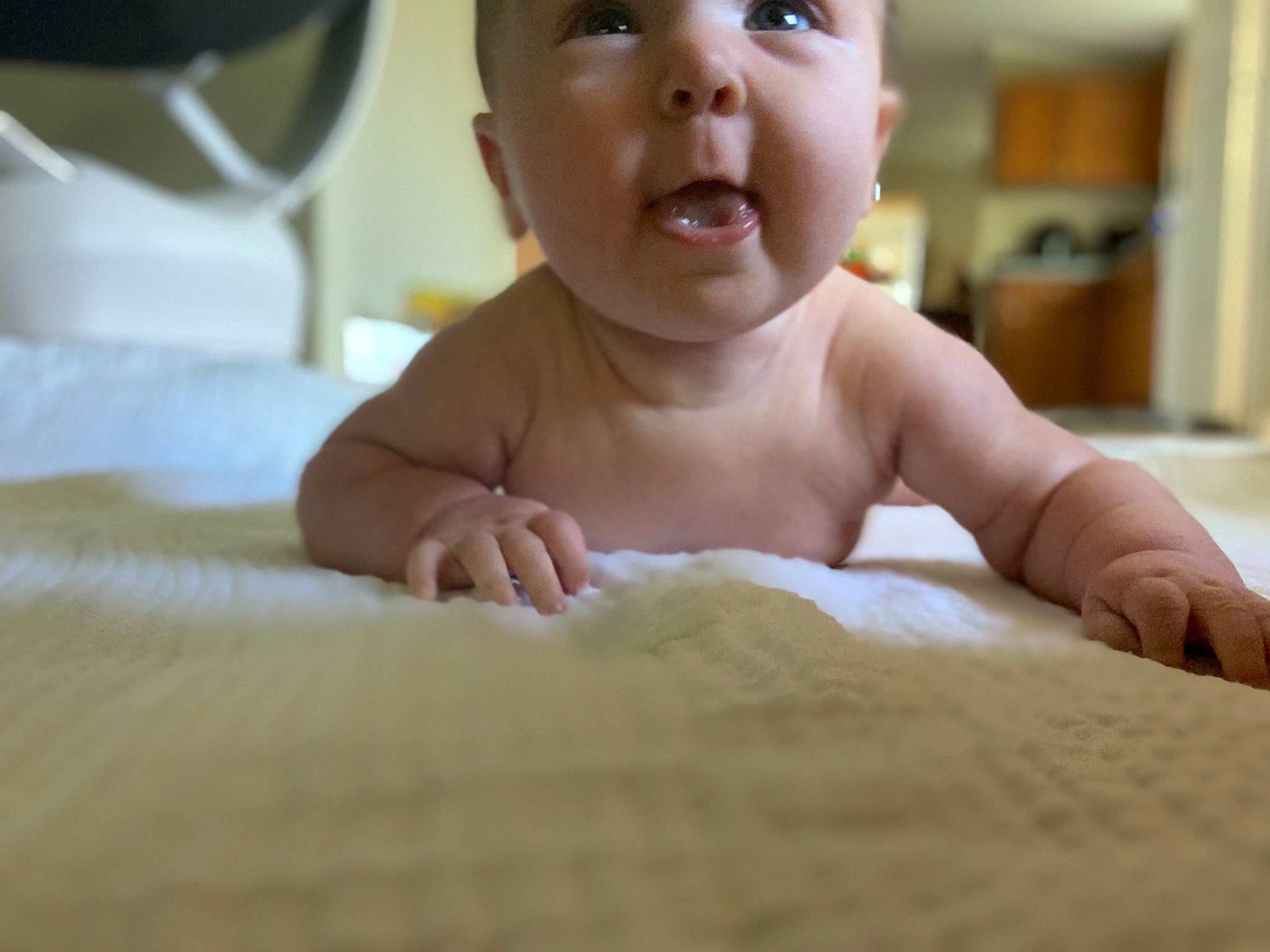 Scarlett is registered to the contest to win money with this photo: baby, cheek, child, chin, face, hand, head, mouth, person, skin, smile, toddler, tummy_time