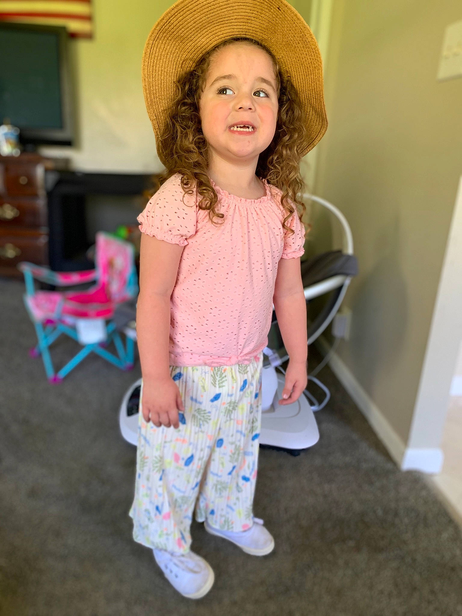 Elizabeth is registered to the contest to win money with this photo: child, child_model, clothing, fashion_accessory, hat, headgear, pattern, person, pink, shoulder, sleeve, smile, standing, sun_hat, t_shirt, toddler