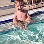 child, toddler, pool, water, splashing, smiling, wet_hair, sunlight, outdoor, summer, happy, people, adult, legs, sitting, relaxing, swimming_pool, fun, play, sun