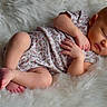 Kasey is registered to the contest to win money with this photo: baby, sleeping, infant, fluffy_blanket, onesie, peaceful, soft_texture, newborn, cozy, cute, resting, child, portrait, skin, hands, feet, relaxation, comfort, indoor, adorable