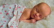 Kasey is registered to the contest to win money with this photo: baby, newborn, sleeping, blanket, floral, face, infant, skin, peaceful, rest, soft, white, fur, cute, child, portrait, closeup, comfort, serene, toddler