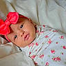 Kasey joined the competition — help win amazing prizes! baby, infant, headband, bow, floral, blanket, swaddle, bed, bedding, face, cute, child, newborn, person, sleepwear, soft, resting, indoors, portrait, skin