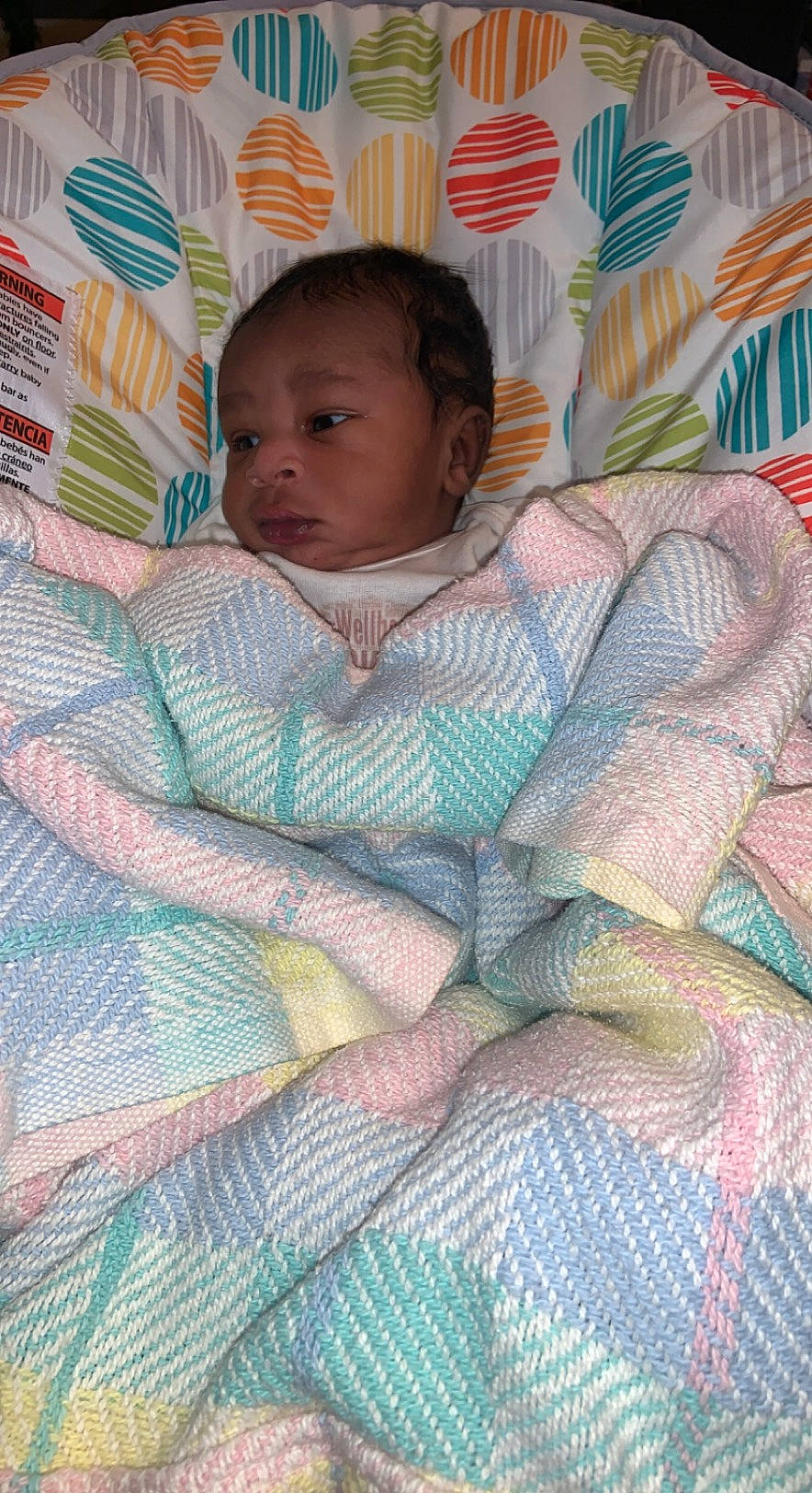 Geovanni is registered to the contest to win money with this photo: art, baby, baby_products, baby_toddler_clothing, bedding, cheek, child, comfort, face, head, iris, lap, linens, pattern, person, pink, room, sitting, skin, toddler