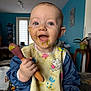 Myla participe au concours pour gagner de l'argent avec cette photo : baby, bib, blue_eyes, child, clothing, cute, dining, face, food, furniture, happy, home, indoor, messy, person, plant, smiling, spoon, table, toddler