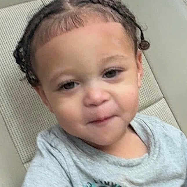 Lennox is registered to the contest to win money with this photo: toddler, child, car_seat, braided_hair, grey_tshirt, yin_yang, portrait, young_child, person, indoor, seat, casual_clothing, cute, smiling, looking_at_camera, short_sleeves, childrens_fashion, car_interior, head_and_shoulders, young_face