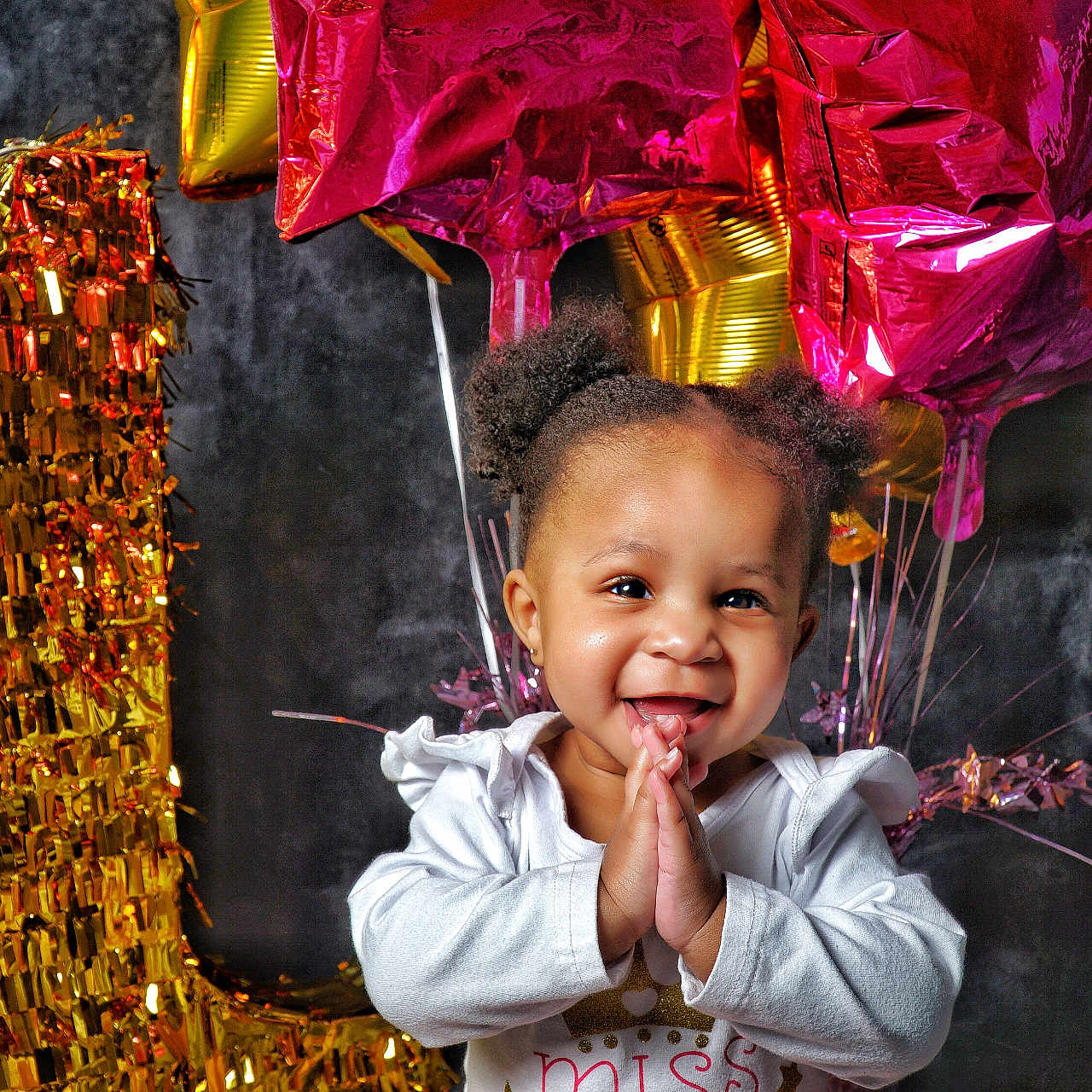 Amaya is registered to the contest to win money with this photo: balloons, birthday, celebration, child, clothing, cute, face, festive, gold, hair, hands, happy, indoor, joyful, number_one, party, pink, portrait, smiling, toddler