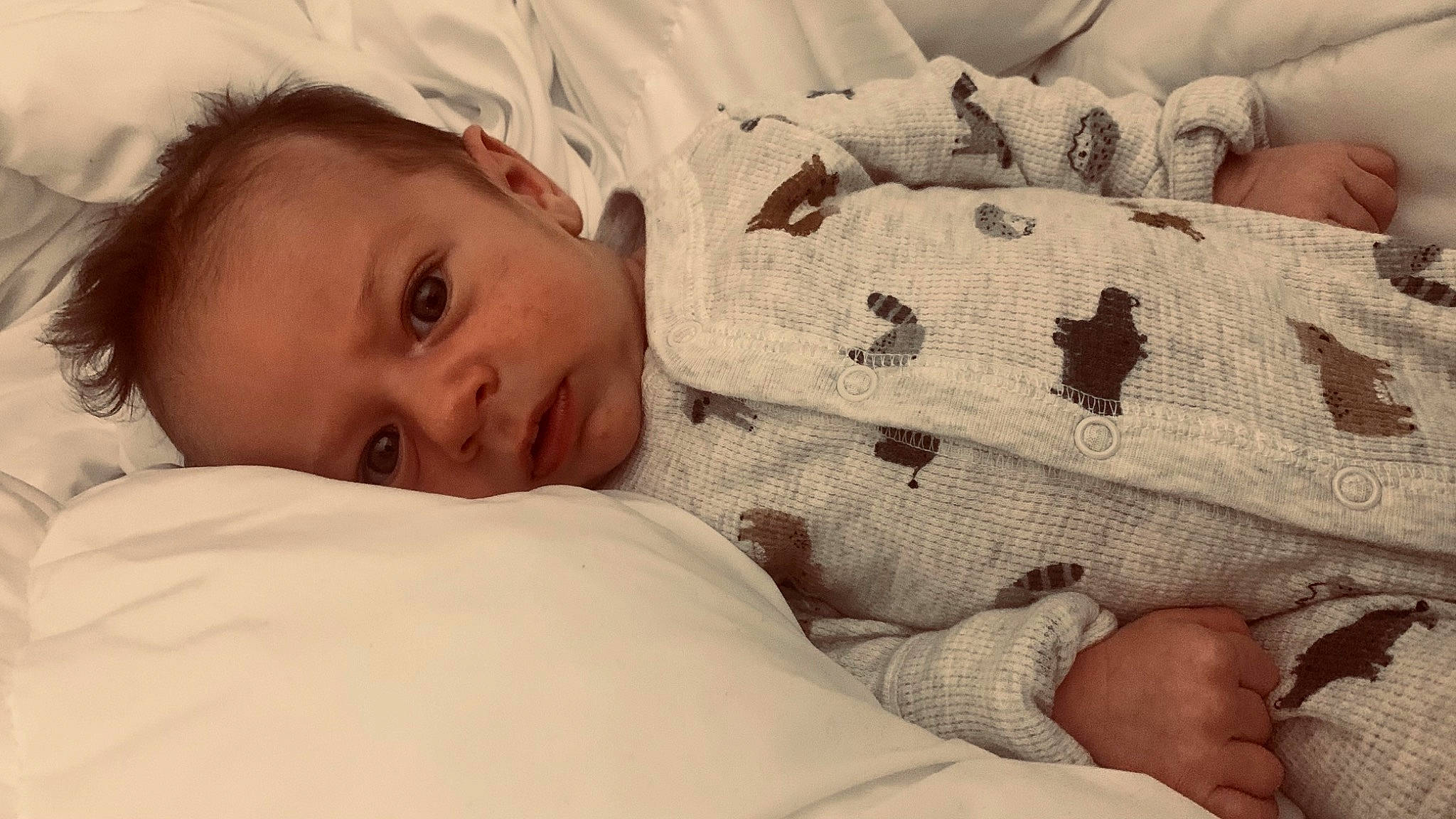 Carson is registered to the contest to win money with this photo: baby_sleeping, bed, bed_sheet, bedding, bedroom, bedtime, child, close_up, comfort, duvet, facial_expression, finger, linens, nose, person, room, skin, sleeve, textile, toddler