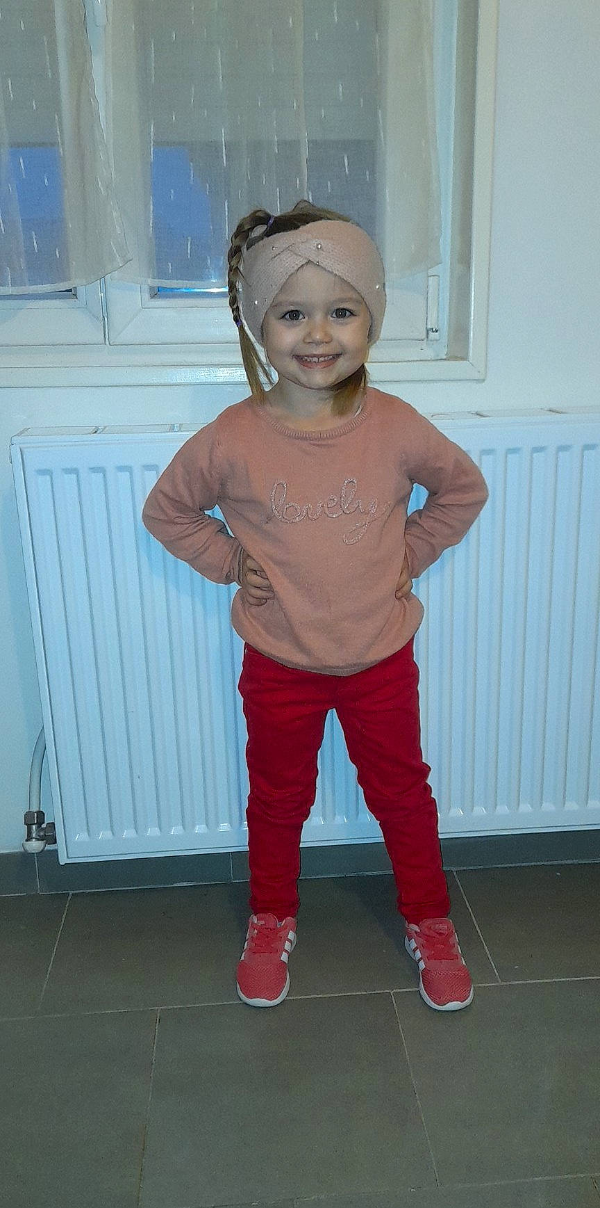 Rosie participe au concours pour gagner de l'argent avec cette photo : baby_toddler_clothing, electric_blue, eye, face, flooring, hair, happy, head, headgear, headwear, joy, knee, person, pink, sleeve, smile, standing, sweatpant, t_shirt, thigh