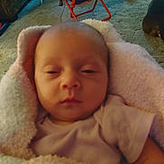 Dnavi joined the competition — help win amazing prizes! newborn, baby, blanket, pink, sleepy, face, infant, person, indoors, carpet, furniture, soft, cozy, home, child, wrapped, portrait, tired, resting, clothing