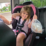 Paisley Mae joined the competition — help win amazing prizes! child, girl, smiling, car, car_seat, road_trip, vehicle, passenger, safety_harness, pink_clothing, blonde_hair, portrait, indoors, gas_station, snack_bag, plastic_bag, daylight, window, outdoor_background, happy
