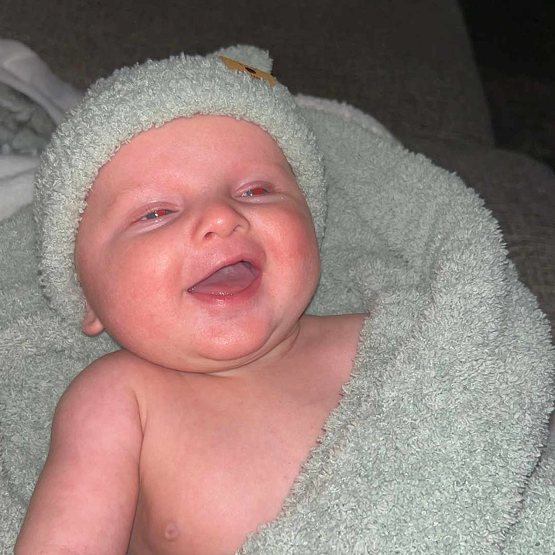 Bentley Everett joined the competition — help win amazing prizes! baby, bathtowel, blanket, bodypart, clothing, face, happy, hat, head, homedecor, laughing, mouth, newborn, person, photography, portrait, quilt, smile, teeth, towel