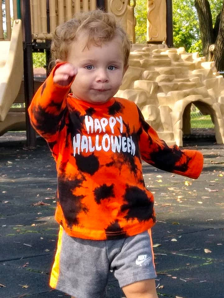 Brycen is registered to the contest to win money with this photo: baby_toddler_clothing, child, finger, grass, hairstyle, happy, leisure, morning, orange, person, photograph, plant, shorts, sleeve, street_fashion, summer, t_shirt, toddler, tree, white