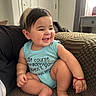 baby, child, smiling, happy, sitting, onesie, clothing, indoor, carpet, blanket, bracelet, face, hair, person, cute, infant, furniture, window, curtains, home