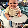 baby, child, infant, smiling, sitting, highchair, tray, clothing, sneakers, indoor, furniture, blanket, toy, face, cheeks, hair, person, seat, table, cute