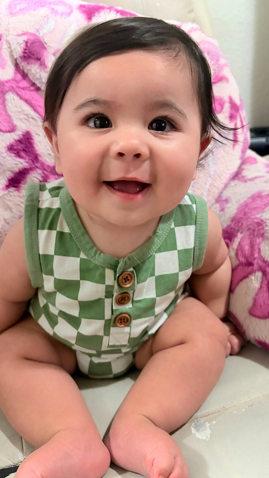 baby, blanket, buttoned_clothing, child, couch, cute, eyes, face, feet, green_checkered_outfit, hands, happy, indoors, infant, legs, portrait, sitting, skin, smiling, young