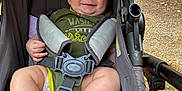 Richard Jr joined the competition — help win amazing prizes! baby, smiling, stroller, outdoor, child, happy, blue_eyes, seatbelt, green_clothing, barefoot, infant, cute, person, sunlight, legs, feet, diaper, fabric, sitting, closeup