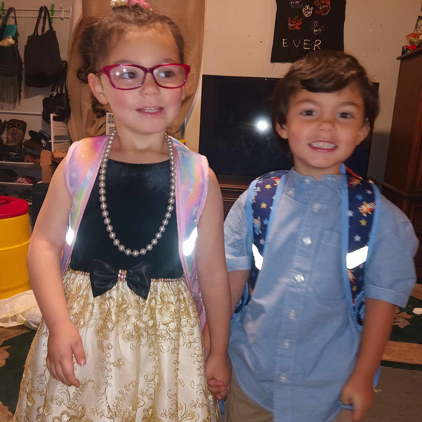 Titania joined the competition — help win amazing prizes! backpack, boy, casual, child, children, clothing, curtain, dress, girl, glasses, hair_accessory, happy, holding_hands, indoor, pearl_necklace, person, room, shirt, smile, television