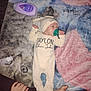 Taylon joined the competition — help win amazing prizes! baby, infant, pacifier, blanket, clothing, hat, lotion, tube, hand, foot, person, lying_down, bedroom, soft_texture, child, sleepwear, newborn, care, comfort, toddler