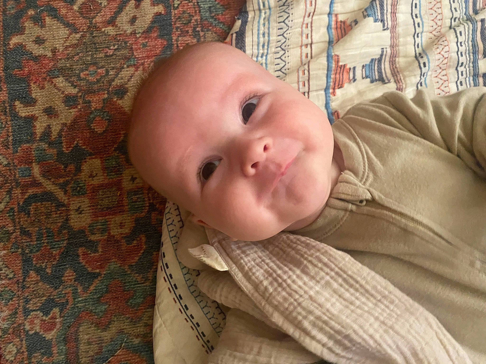 Benji is registered to the contest to win money with this photo: baby, baby_toddler_clothing, cheek, child, comfort, eye, happy, iris, linens, lip, nose, pattern, person, portrait_photography, room, smile, toddler, wood