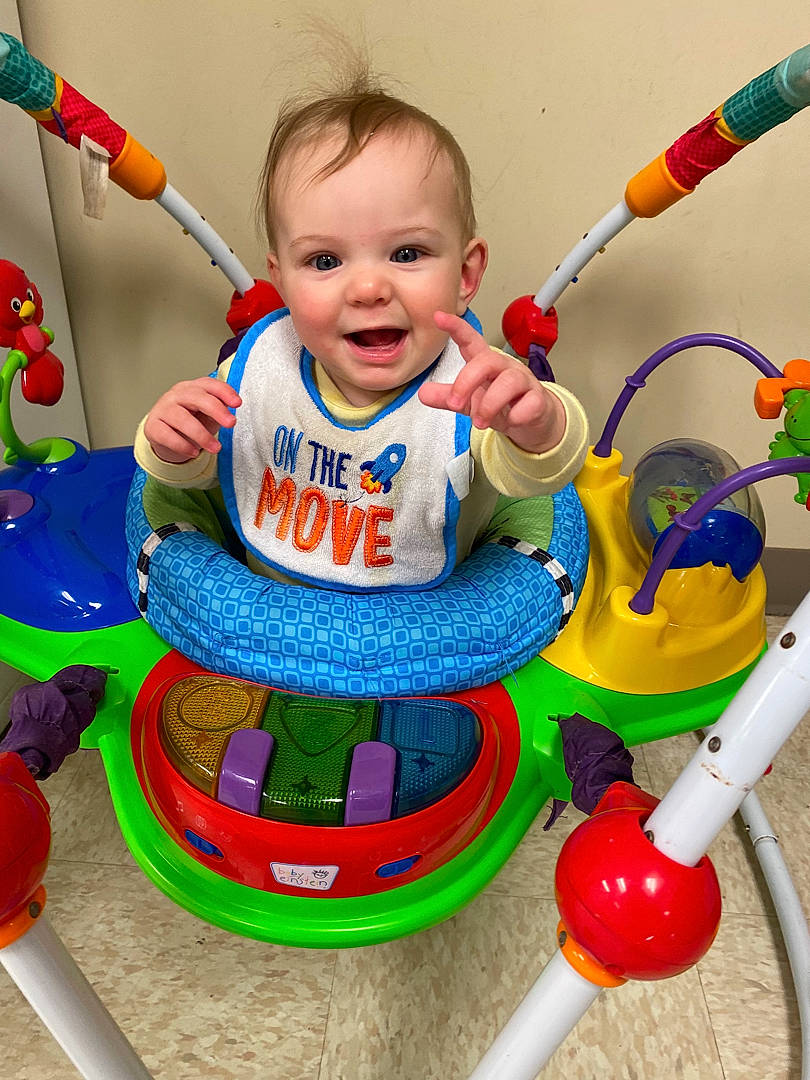 Nolie is registered to the contest to win money with this photo: arm, baby, baby_playing_with_toys, baby_products, baby_toddler_clothing, baby_toys, child, event, fun, hand, happy, party_supply, person, play, product, recreation, riding_toy, smile, toddler, toy