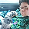 Dj joined the competition — help win amazing prizes! person, puppy, dog, glasses, car_interior, window, seat, shirt, cartoon_character, sleeping, pet, animal, cozy, resting, young_dog, casual_clothing, indoor, travel, companion, cute