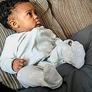 Miss'Minnie joined the competition — help win amazing prizes! baby, infant, pajamas, star_pattern, couch, striped, clothing, socks, person, indoor, portrait, cute, relaxed, child, seated, looking_away, soft_fabric, home, cozy, young