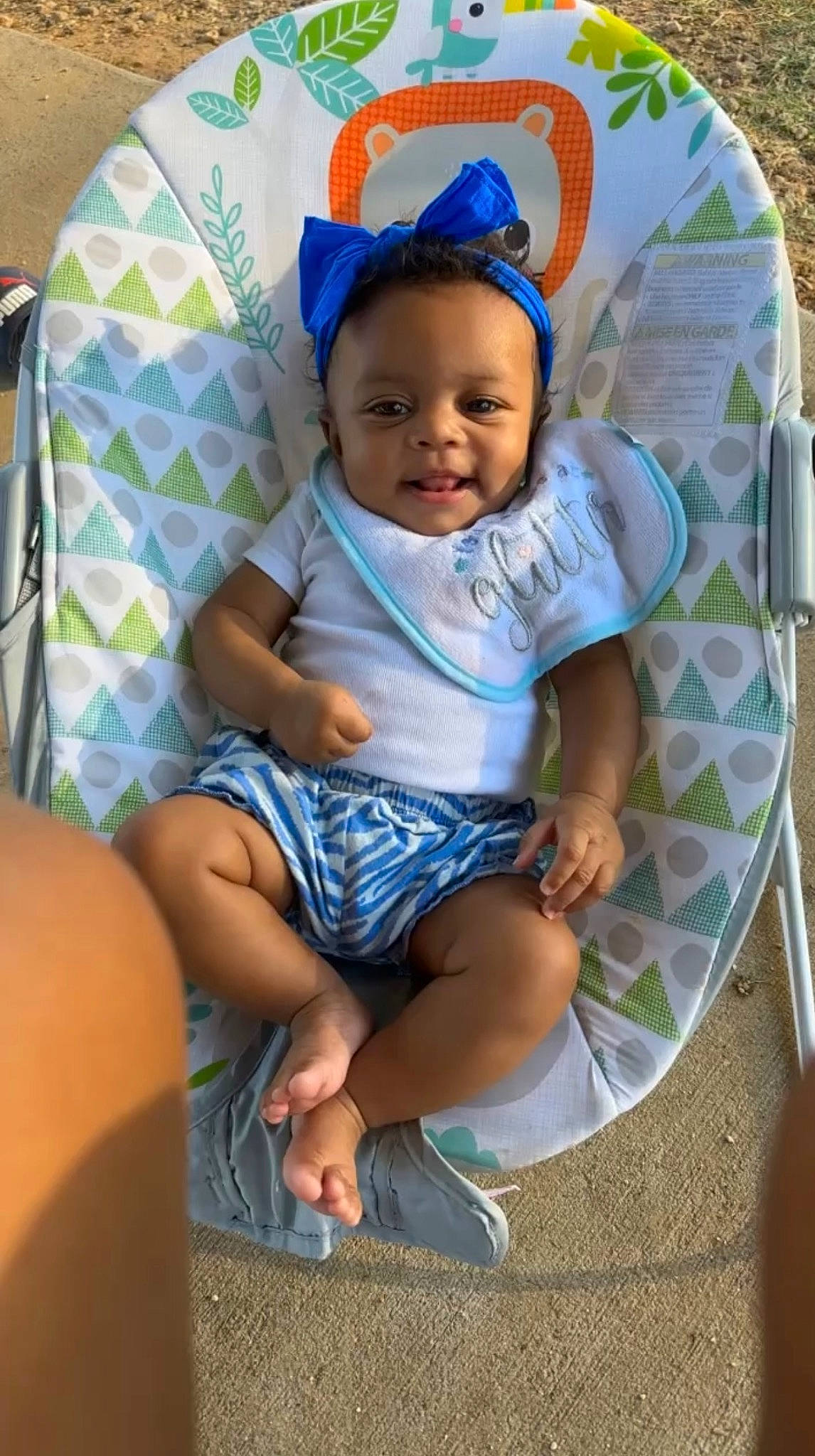 Tenylah is registered to the contest to win money with this photo: baby, baby_products, baby_toddler_clothing, chair, child, comfort, event, foot, fun, happy, human_leg, lap, leisure, person, sandal, shorts, sitting, smile, t_shirt, thigh