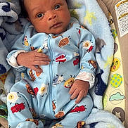 Nyaire joined the competition — help win amazing prizes! baby, infant, blanket, onesie, blue_clothing, baby_seat, patterned_clothing, food_characters, cute, young_child, indoors, colorful, comfort, face, hand, footed_pajamas, soft_texture, portrait, child, newborn