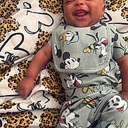 Nyaire joined the competition — help win amazing prizes! baby, bed, bib, blanket, cartoon, child, clothing, cozy, face, happy, indoor, infant, laughing, leopard_print, lying_down, mickey_mouse, playful, portrait, smiling, sock