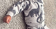 Nyaire joined the competition — help win amazing prizes! baby, carpet, casual, child, clothing, cozy, cute, dinosaur_pattern, happy, hoodie, indoor, infant, lying_down, portrait, relaxed, small_person, smiling, sock, soft_texture, young_child