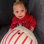 Laniyah joined the competition — help win amazing prizes! baby, child, hoodie, red_clothing, plush_toy, smile, face, couch, indoor, cute, young_child, person, soft_toy, striped, seated, happy, cozy, casual, portrait, infant