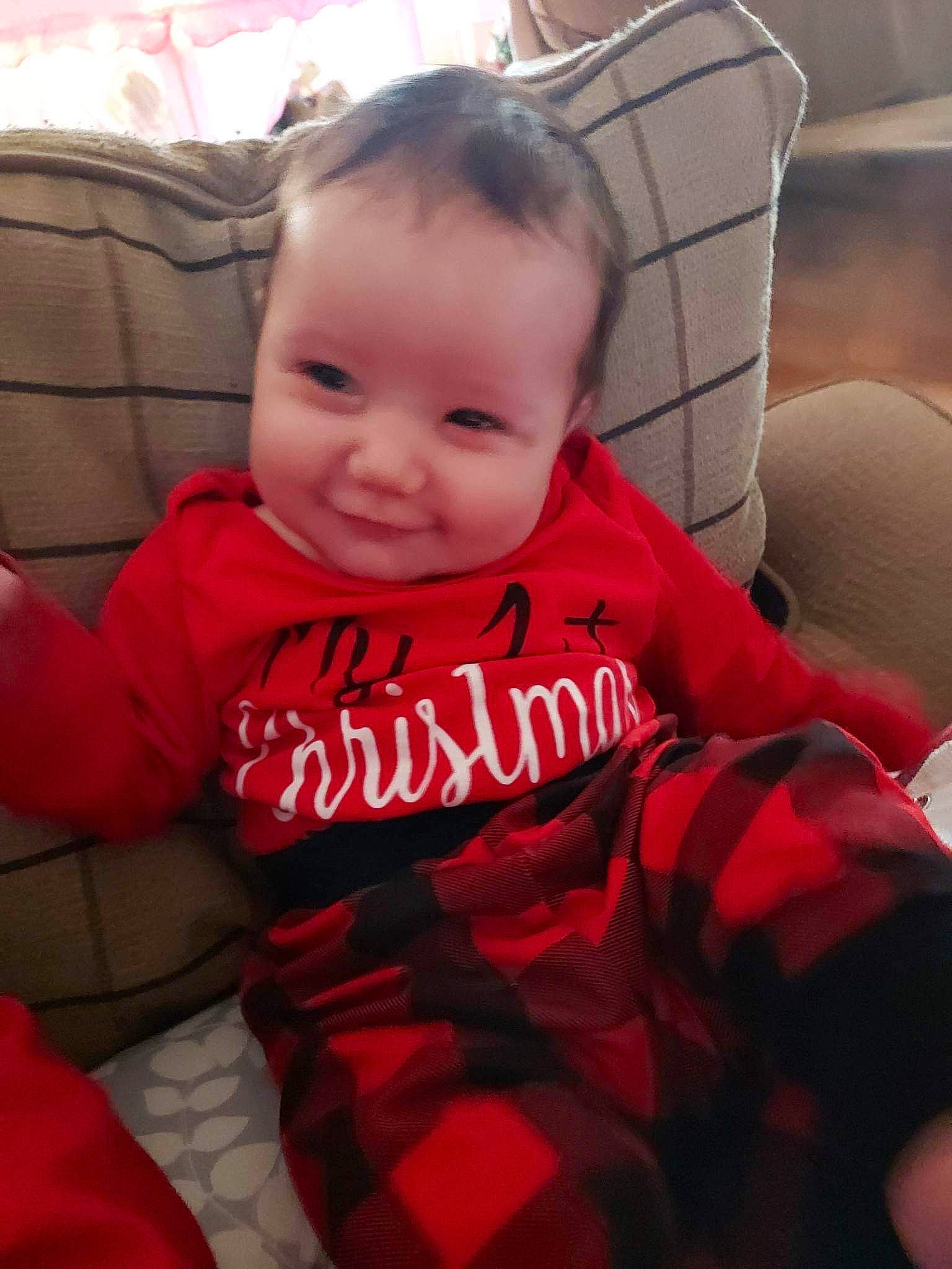 Paisley is registered to the contest to win money with this photo: baby, baby_products, baby_toddler_clothing, comfort, cool, couch, finger, fun, happy, lap, pattern, person, plaid, sitting, skin, sleeve, smile, t_shirt, tartan, tints_and_shades