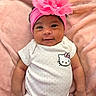 baby, infant, smiling, headband, pink_flower, onesie, hello_kitty, blanket, soft_texture, cute, child, portrait, happy, lying_down, indoors, skin, clothing, baby_girl, adorable, head_shot