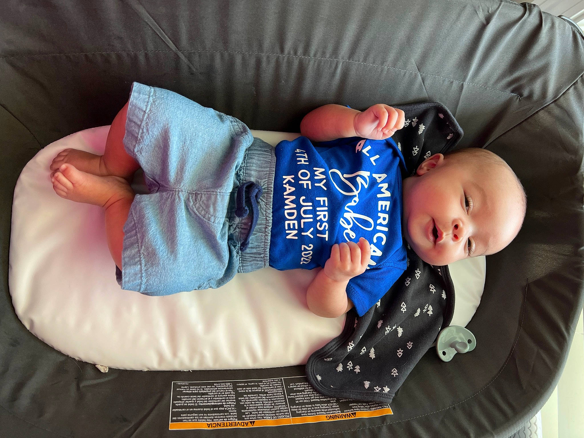 Kamden is registered to the contest to win money with this photo: baby, baby_products, baby_sleeping, baby_toddler_clothing, child, comfort, couch, finger, hat, headgear, human_body, leg, linens, pattern, person, product, sitting, skin, sleeve, textile