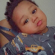 Nicholas is registered to the contest to win money with this photo: toddler, child, pajamas, indoor, portrait, face, expression, black_hearts, filter, clothing, person, baby, cute, young_child, sleepwear, monsters_trucks, pout, skin, hair, casual