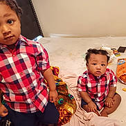 Noah is registered to the contest to win money with this photo: child, toddler, baby, plaid_shirt, matching_outfits, bed, blanket, snack, cheese_puffs, messy_room, indoor, curious, sitting, standing, person, hair, face, clothing, expression, casual