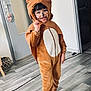 animal_costume, cape, child, childhood, costume, cute, door, ears, face_paint, floor, happy, home, hood, indoor, person, playful, portrait, smiling, socks, wooden_floor