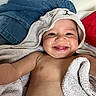 Lizio a rejoint le concours — aidez-le/la à gagner de superbes lots ! baby, smiling, towel, hooded_towel, cute, child, happy, skin, blanket, fabric, indoor, portrait, infant, baby_face, person, small_child, cute_expression, cozy, reaching_out, red_background