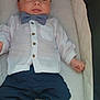 baby, infant, bow_tie, white_shirt, navy_pants, blue_shoes, lying_down, baby_carrier, cute, child, fashion, portrait, clothing, footwear, small, adorable, young, infant_boy, comfortable, indoors