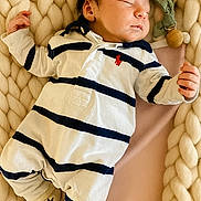 Marceau participe au concours pour gagner de l'argent avec cette photo : baby, newborn, sleeping, onesie, striped_clothing, blanket, chunky_knit, pacifier_clip, cozy, cute, infant, child, soft, resting, indoors, portrait, peaceful, small_hands, cuddly, warm
