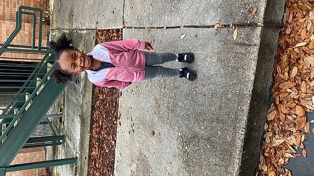 Arya joined the competition — help win amazing prizes! child, city, concrete, fun, jacket, joy, leisure, line, magenta, outdoor_shoe, pedestrian, person, recreation, red, road_surface, sidewalk, sitting, sneakers, street_fashion, toddler