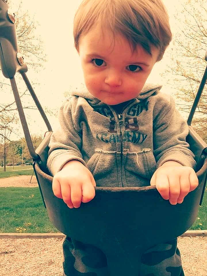 Haidyn is registered to the contest to win money with this photo: baby, blond, child, city, eye, fun, grass, happy, human_settlement, nose, outdoor_play_equipment, person, play, playground, public_space, recreation, smile, swing, toddler