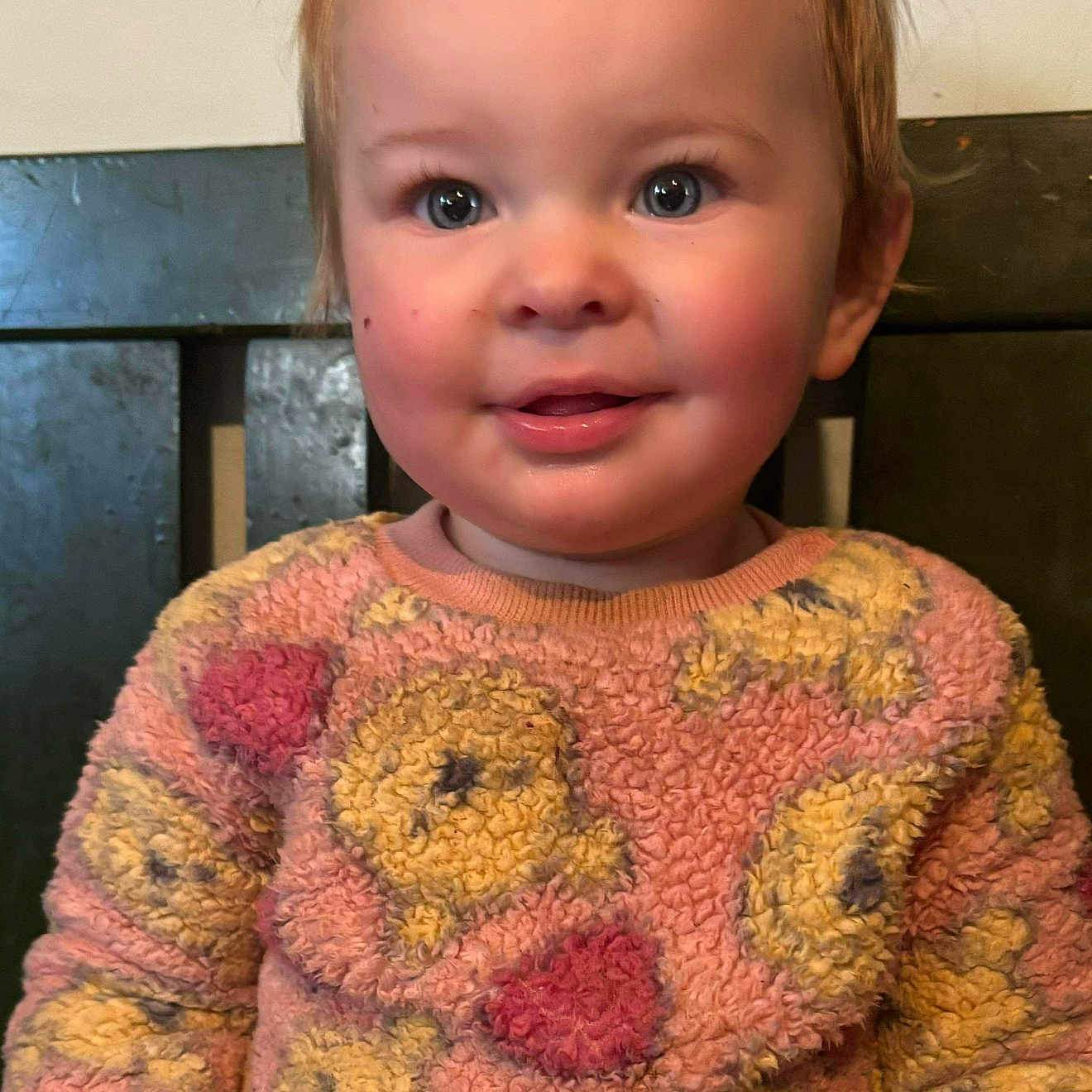 Mia Rose joined the competition — help win amazing prizes! blue_eyes, child, close_up, cozy, cute, hair_clips, happy, indoor, patterned_clothing, person, pink, portrait, rosy_cheeks, seated, smiling, sweater, toddler, warm_colors, yellow, young_child