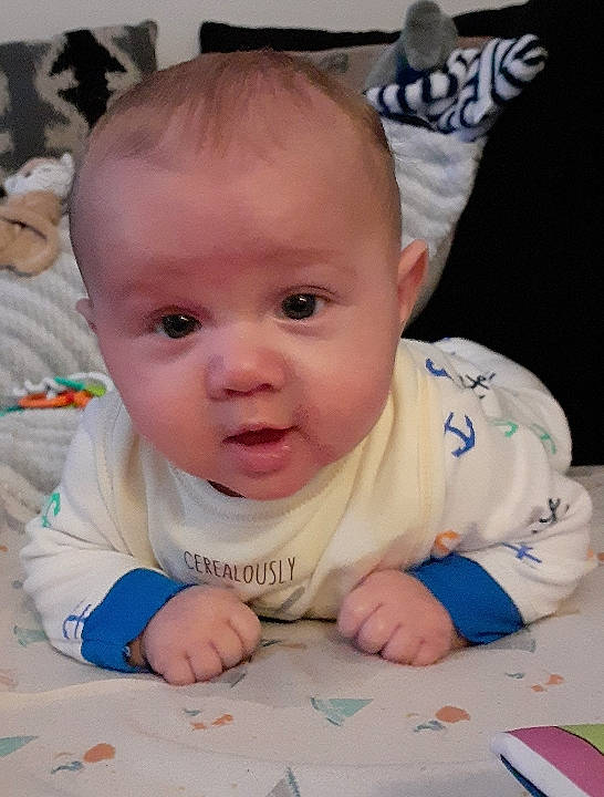 Zachariah is registered to the contest to win money with this photo: baby, baby_toddler_clothing, cheek, chin, eye, eyebrow, finger, flooring, fun, hairstyle, happy, head, iris, lip, mouth, nose, person, skin, smile, toddler