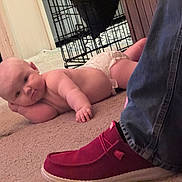 Hadley joined the competition — help win amazing prizes! baby, diaper, carpet, indoor, person, jeans, shoe, red_shoe, footwear, floor, head, hand, relaxed, lying_down, cage, home, casual, infant, cute, skin