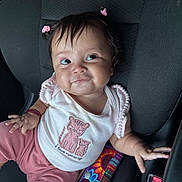 Luz joined the competition — help win amazing prizes! baby, child, infant, car_seat, pink_clothing, hair_ties, cute, smile, face, portrait, sitting, hand, clothing, tiger_embroidery, seatbelt, interior, car, expression, young_child, adorable