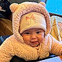 Luz joined the competition — help win amazing prizes! baby, child, face, hat, hoodie, pink, smile, indoor, cozy, couch, warm, cute, knit, apparel, person, portrait, young_child, happy, seated, closeup