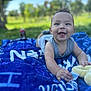 baby, smiling, outdoor, blanket, grass, blue_sky, happy, child, infant, nature, playful, cute, young_child, portrait, sunlight, daytime, clothing, relaxing, toy, face