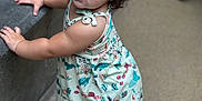 Maisie is registered to the contest to win money with this photo: toddler, child, barefoot, curly_hair, blue_eyes, dress, standing, concrete, floor, leaning, expression, portrait, outdoor, casual_clothing, baby, person, young_child, cute, curiosity, natural_light